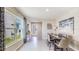 Bright dining room with large windows, table, and modern art at 30916 Wild Juniper Ct, Brooksville, FL 34602