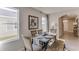 Rustic dining area with wooden table and bench, and adjacent hallway at 30922 Wild Juniper Ct, Brooksville, FL 34602