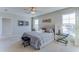 Main bedroom with tufted headboard, large windows, and walk-in closet at 30922 Wild Juniper Ct, Brooksville, FL 34602