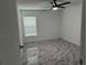 Well-lit bedroom featuring a ceiling fan and marble-look floors at 3619 Marco Dr, Tampa, FL 33614