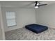 Spacious bedroom with ceiling fan, window blinds, and grey marble-look floors at 3619 Marco Dr, Tampa, FL 33614