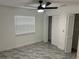 Bedroom with ceiling fan, window blinds, and spacious closet at 3619 Marco Dr, Tampa, FL 33614