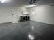 Garage with laundry hookups, storage cabinets, and epoxy floor at 3619 Marco Dr, Tampa, FL 33614