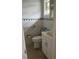 Clean bathroom with white vanity and green accents at 610 Fox St, Longboat Key, FL 34228