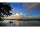 Peaceful scene of a person kayaking on calm waters near a lush wetland at 13221 Gulf Bay Ln, Spring Hill, FL 34609