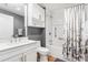Clean bathroom with white vanity, shower/tub combo, and floral curtain at 920 N Osceola Ave # 604, Clearwater, FL 33755