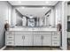 Double vanity bathroom with modern white cabinets and gold accents at 920 N Osceola Ave # 604, Clearwater, FL 33755