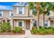 Tan two-story townhome with white shutters, a door, and landscaping at 6266 Triple Tail Ct # 103, Lakewood Ranch, FL 34202