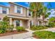 Tan two-story townhome with white shutters and landscaping at 6266 Triple Tail Ct # 103, Lakewood Ranch, FL 34202