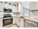 Stainless steel appliances and white cabinetry in kitchen at 6266 Triple Tail Ct # 103, Lakewood Ranch, FL 34202