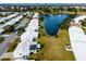 Aerial view of community with lake and numerous homes at 9205 40Th N Way # 5, Pinellas Park, FL 33782