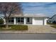 White single story home with teal shutters, attached garage, and landscaped lawn at 9205 40Th N Way # 5, Pinellas Park, FL 33782