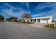 Street view of a neighborhood with similar white homes at 9205 40Th N Way # 5, Pinellas Park, FL 33782