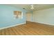 Light and airy living room with wood-look floors and a view of the kitchen at 9205 40Th N Way # 5, Pinellas Park, FL 33782