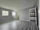 Bright bedroom with wood-look flooring and ensuite bathroom at 12117 Topaz St, Spring Hill, FL 34608