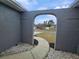 Curved walkway leads to arched entryway with gray stucco walls at 12117 Topaz St, Spring Hill, FL 34608