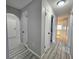 Bright hallway with grey walls and wood-look flooring at 12117 Topaz St, Spring Hill, FL 34608