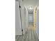 Long hallway with light gray walls and wood-look floors at 12117 Topaz St, Spring Hill, FL 34608