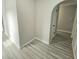 View of a hallway with wood-look flooring and archway at 12117 Topaz St, Spring Hill, FL 34608