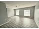 Living room with wood-look flooring and large windows at 12117 Topaz St, Spring Hill, FL 34608