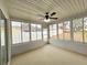 Bright sunroom with view of backyard and ceiling fan at 12117 Topaz St, Spring Hill, FL 34608