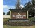 Sherman Oaks community sign with landscaping and address at 30900 Wild Juniper Ct, Brooksville, FL 34602