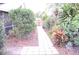 Landscaped backyard with a walkway and lush greenery at 812 Walsingham Way, Valrico, FL 33594