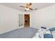 Cozy bedroom with carpet flooring and access to another room at 11847 Dunster Ln, Parrish, FL 34219
