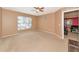 Spacious bedroom with ceiling fan and large window at 11847 Dunster Ln, Parrish, FL 34219