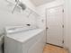 Laundry room with washer, dryer, and shelving at 11847 Dunster Ln, Parrish, FL 34219