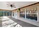 Bright, screened porch with ceiling fan, window, and door access at 11847 Dunster Ln, Parrish, FL 34219