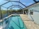 Relaxing screened pool area featuring a large, sparkling pool and ample patio space for lounging and entertaining at 1280 Windy Bay Shl, Tarpon Springs, FL 34689