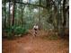 Person mountain biking on a wooded trail at 14096 Sand Plover Ave, Brooksville, FL 34614