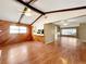 Open living room with wood paneled accent wall, beamed ceilings, and wood laminate flooring at 1314 Sunfish Dr, Brandon, FL 33511