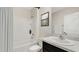 Bright bathroom featuring a shower-tub, granite counters, modern fixtures, and tile backsplash at 7718 Rome Ln, Brooksville, FL 34613