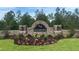 Landscaped entrance to the Waterford community with stone signage and mature trees at 7718 Rome Ln, Brooksville, FL 34613