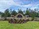 Stone entrance sign for the Waterford community with manicured landscaping at 7710 Rome Ln, Brooksville, FL 34613