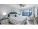 Comfortable bedroom featuring water view, ceiling fan, and stylish coastal decor at 6372 Palma Del Mar S Blvd # Apt 307, St Petersburg, FL 33715