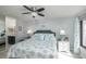 Bright bedroom featuring a queen bed, ceiling fan, and ensuite bathroom at 6372 Palma Del Mar S Blvd # Apt 307, St Petersburg, FL 33715