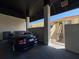 Carport view featuring a parked car and stairs to a tan building in the background at 6372 Palma Del Mar S Blvd # Apt 307, St Petersburg, FL 33715