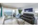 Living room with water views, leather seating, and glass sliding doors to the balcony at 6372 Palma Del Mar S Blvd # Apt 307, St Petersburg, FL 33715