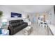 Open-concept living room boasts modern furnishings, light wood floors, and a dining area at 6372 Palma Del Mar S Blvd # Apt 307, St Petersburg, FL 33715