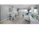 Living room with dining area, seating, water views, and sliding glass doors to the balcony at 6372 Palma Del Mar S Blvd # Apt 307, St Petersburg, FL 33715