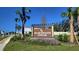 Sherman Oaks community sign surrounded by lush landscaping and blue sky at 30886 Wild Juniper Ct, Brooksville, FL 34602