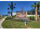 Community sign for Sherman Oaks amidst lush landscaping and clear blue skies at 30910 Silver Stage Dr, Brooksville, FL 34602