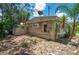 House exterior with landscaping and shed at 1422 Bayshore Rd, Ruskin, FL 33570