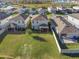 Aerial view of houses with backyard, showcasing community landscape at 10662 Hawks Landing Dr, Land O Lakes, FL 34638