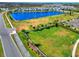 Community lot with large grassy area near pond and road at 10662 Hawks Landing Dr, Land O Lakes, FL 34638