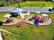 Community playground with play structures and shaded areas at 10662 Hawks Landing Dr, Land O Lakes, FL 34638