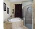 Bathroom with shower and corner bathtub at 5516 Luminar Pointe Ln, Apollo Beach, FL 33572